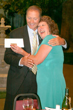 Meatball Baker inventor hugging Mr. Davison after receiving royalty check