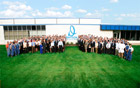 A photo of Davison employees standing behind Mr. Davison, CEO and Founder. Photo Credit: Davison