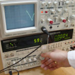 Designer using a oscilloscope