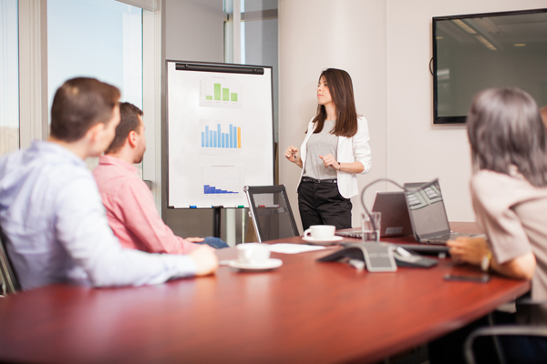 Woman pitching in board room Presenting